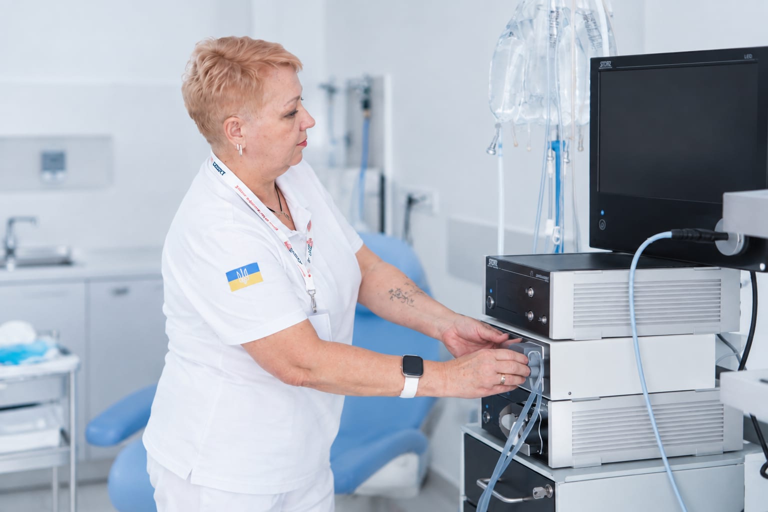 A nurse sets up the endoscopy equipment in the gynecologic oncology examination room